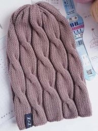 Шапка с косами, связанная спицами